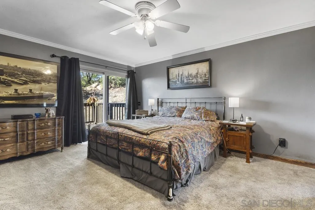 13492 Jamul Drive Jamul, CA 91935 - Photo 10 of 24 a bedroom with a bed and a large window