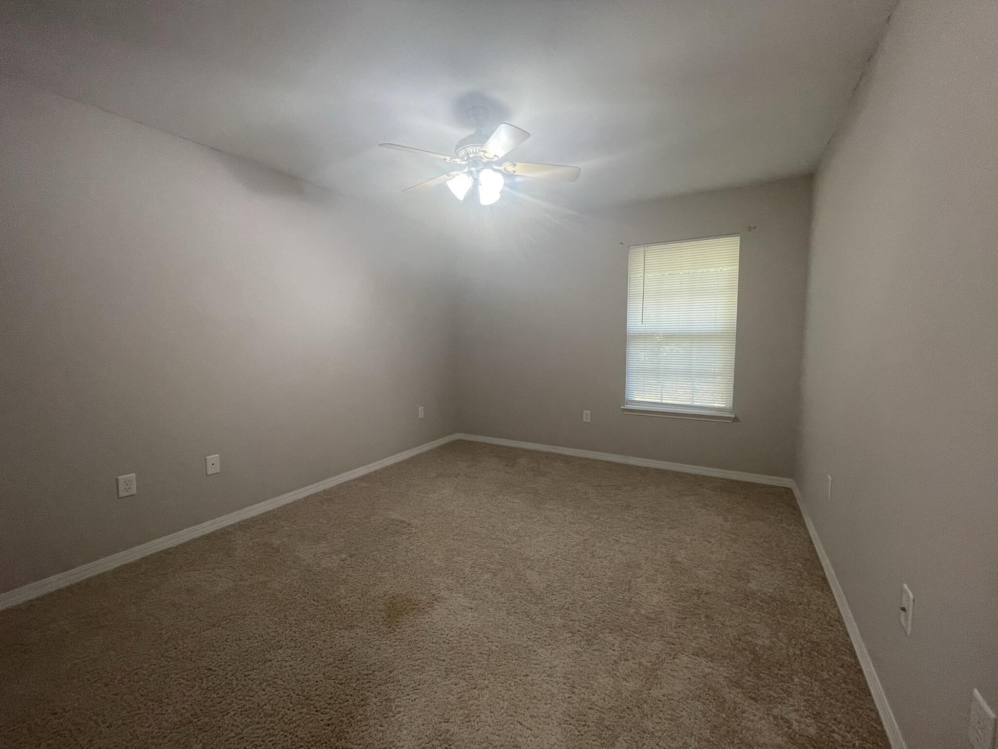 4270 Painter Branch Road Crestview, FL 32539 - Photo 12 of 15 an empty room with a window and a fan