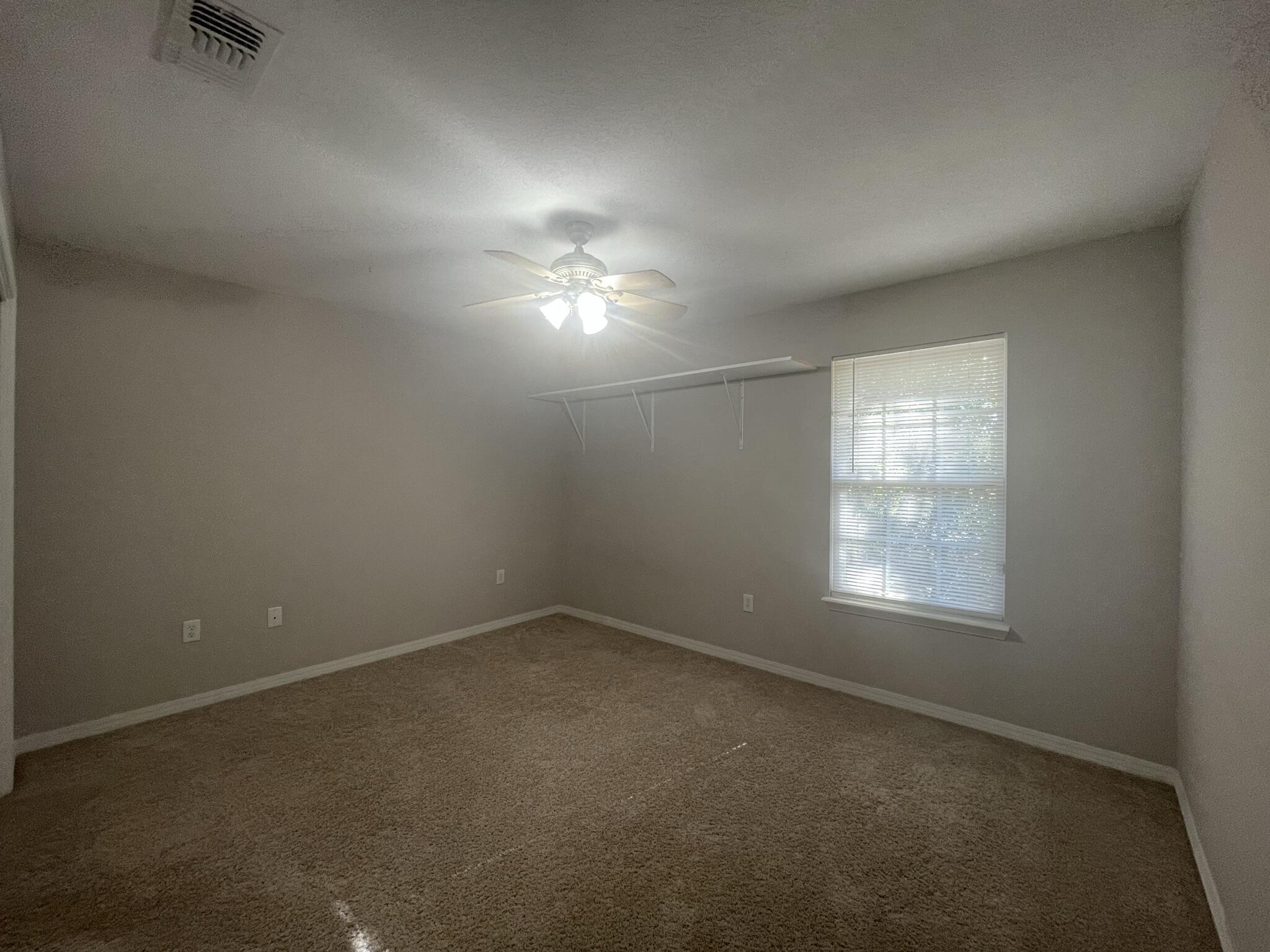 4270 Painter Branch Road Crestview, FL 32539 - Photo 14 of 15 an empty room with a empty space and windows
