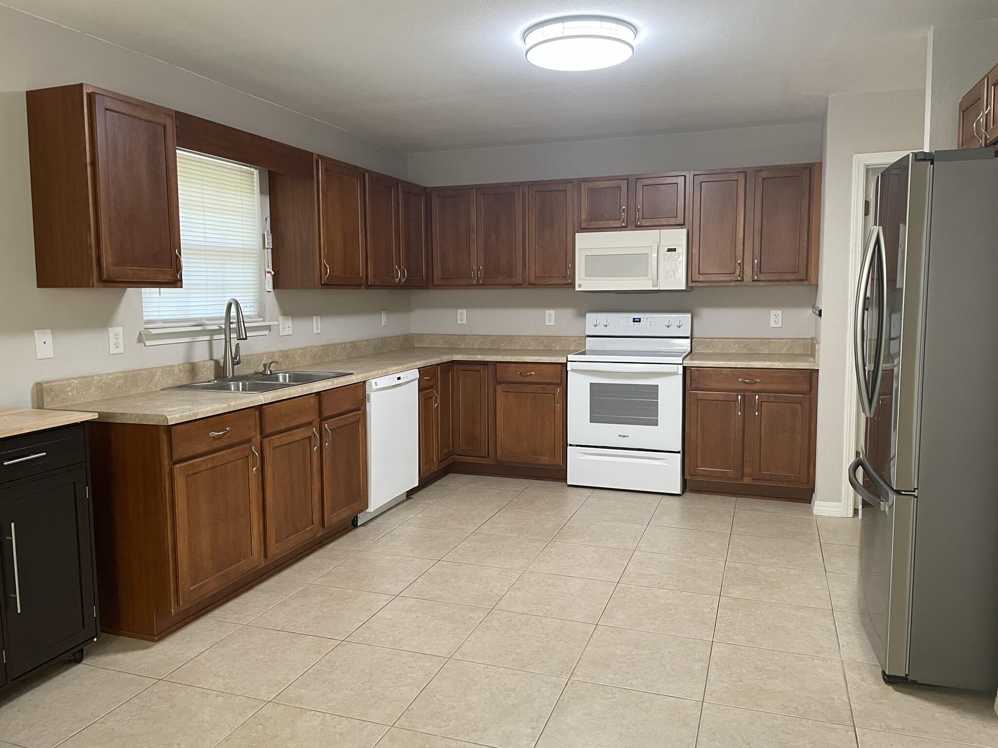 4270 Painter Branch Road Crestview, FL 32539 - Photo 4 of 15 a kitchen with a sink a refrigerator and cabinets