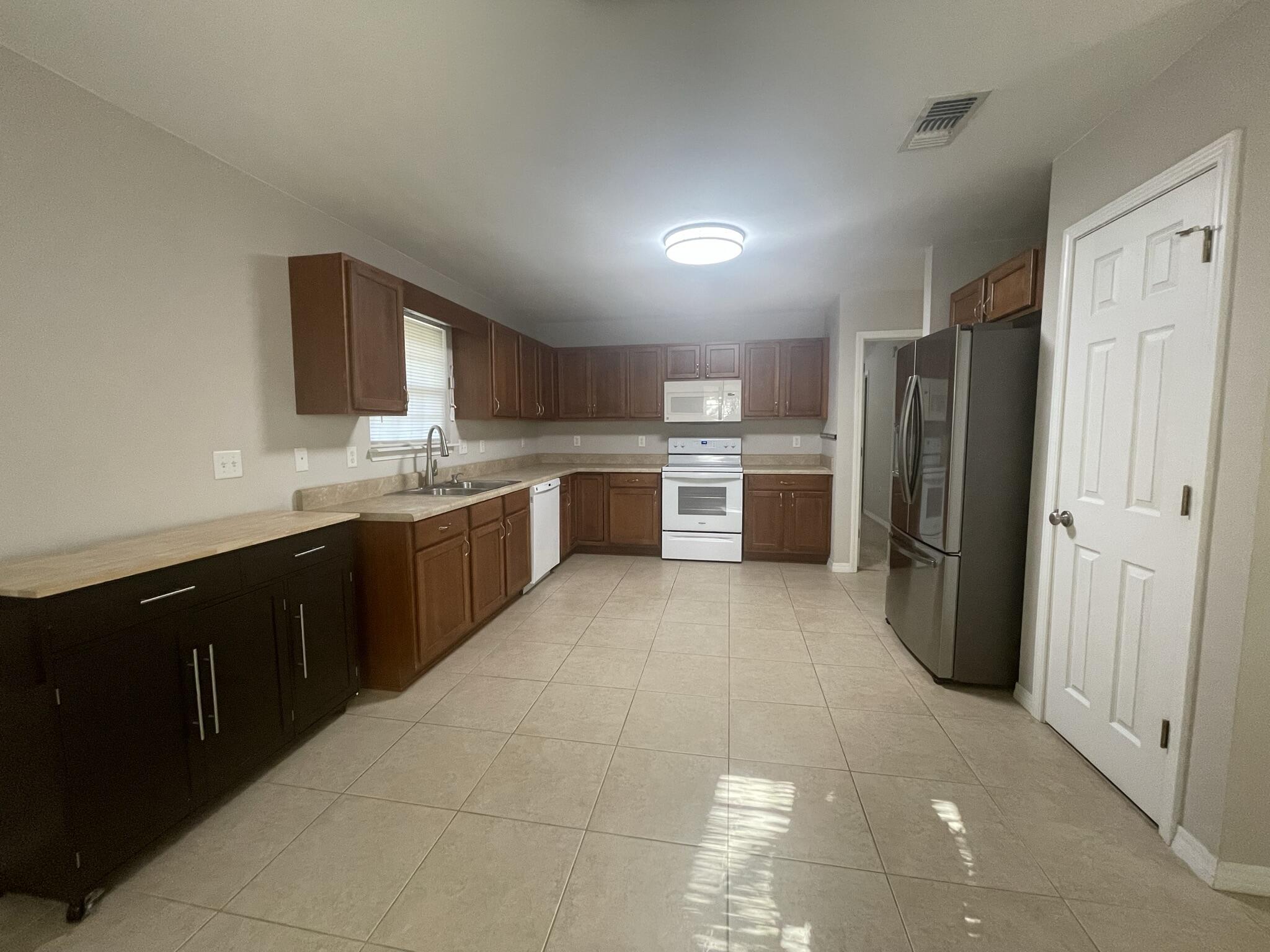 4270 Painter Branch Road Crestview, FL 32539 - Photo 5 of 15 a large kitchen with a refrigerator and a sink