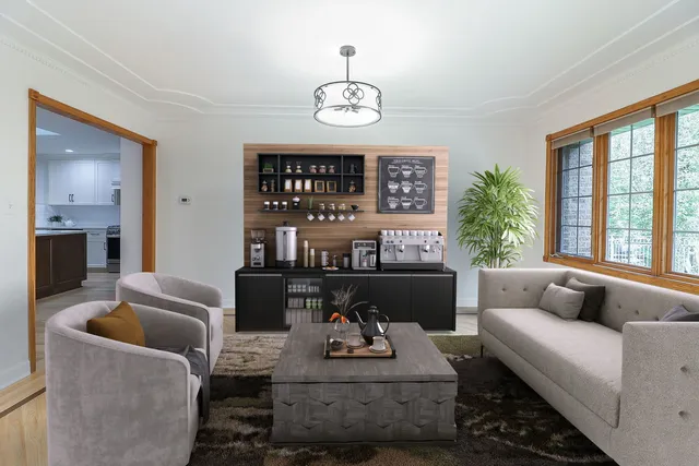 a living room with furniture chandelier and fireplace