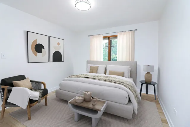 a bedroom with a bed and chair