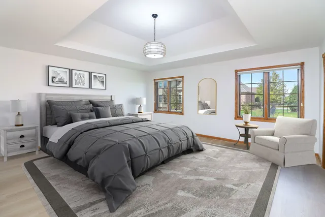 a spacious bedroom with a large bed couch and a window