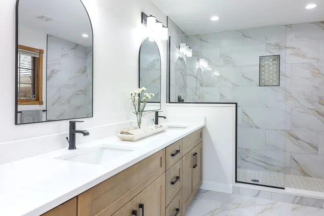 a bathroom with a double vanity sink mirror and