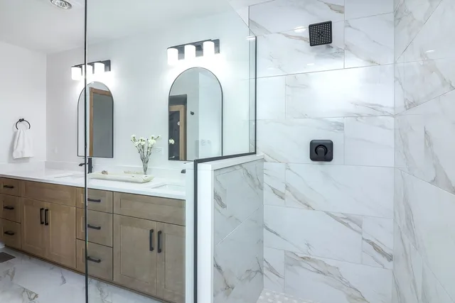a bathroom with a double vanity sink and mirror