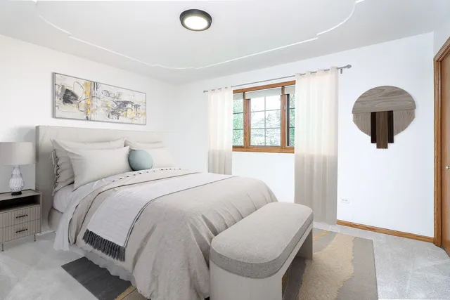 a bedroom with a bed and a painting on the wall