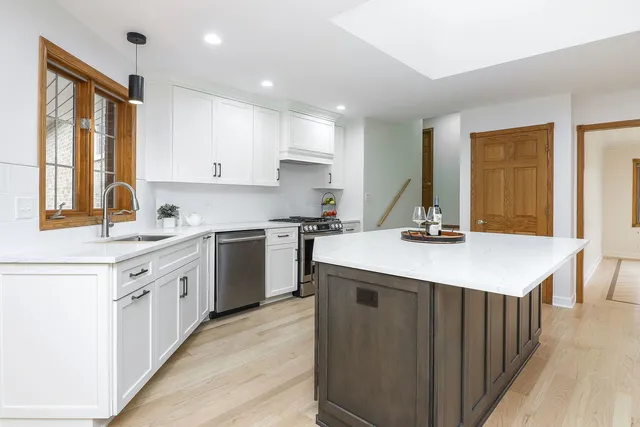 a kitchen with a sink stove and cabinets