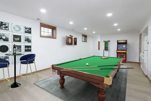 a room with pool table and windows