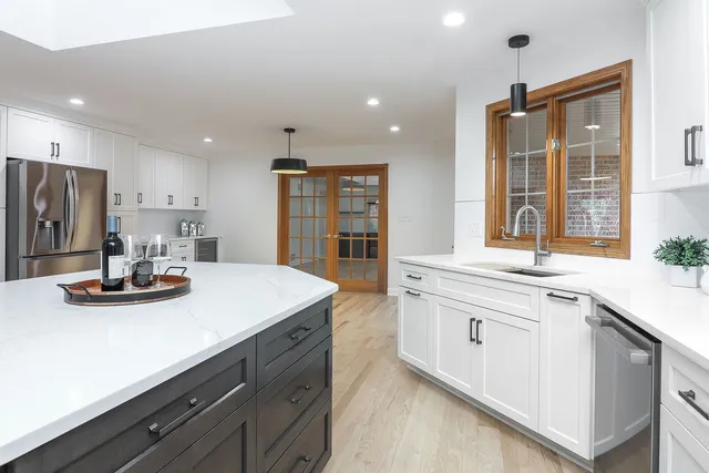 a kitchen with kitchen island granite countertop stainless steel appliances sink stove and cabinets