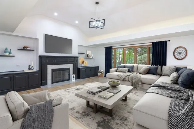 a living room with furniture a fireplace and a flat screen tv