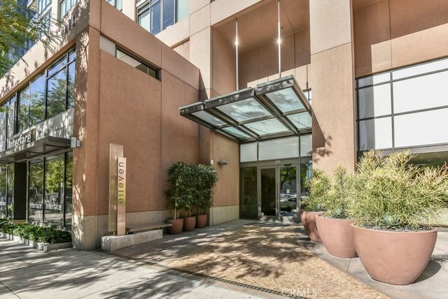 a view of a city street lined with buildings and trees