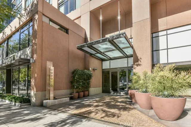 a view of a city street lined with buildings and trees