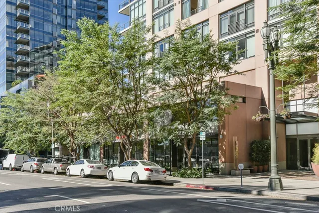 a kitchen with kitchen island a counter top space a sink stainless steel appliances and cabinets