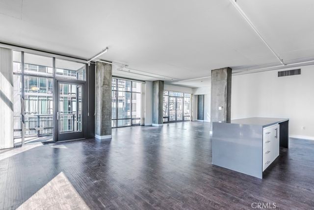 a view of a kitchen with a sink and cabinets