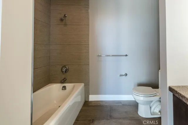 a bathroom with a toilet and a bathtub