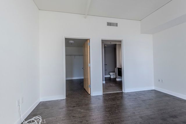 a view of an empty room and wooden floor
