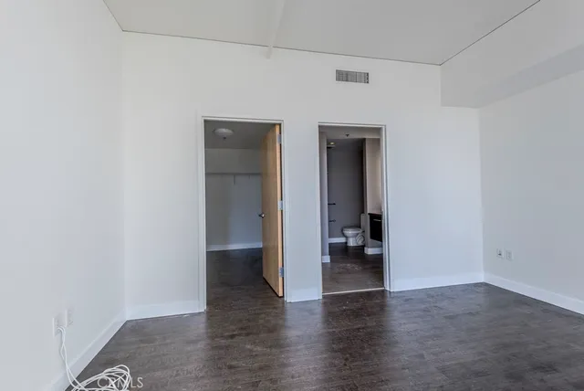 a view of an empty room and wooden floor
