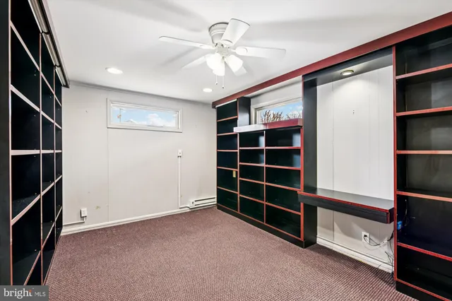 a view of an empty room with a fireplace and a window