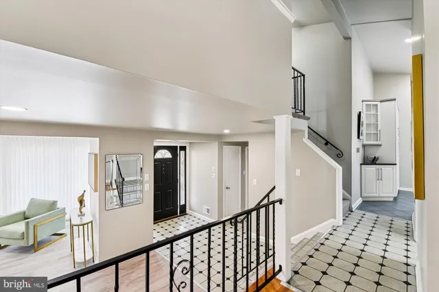 a view of a hallway with windows and stairs