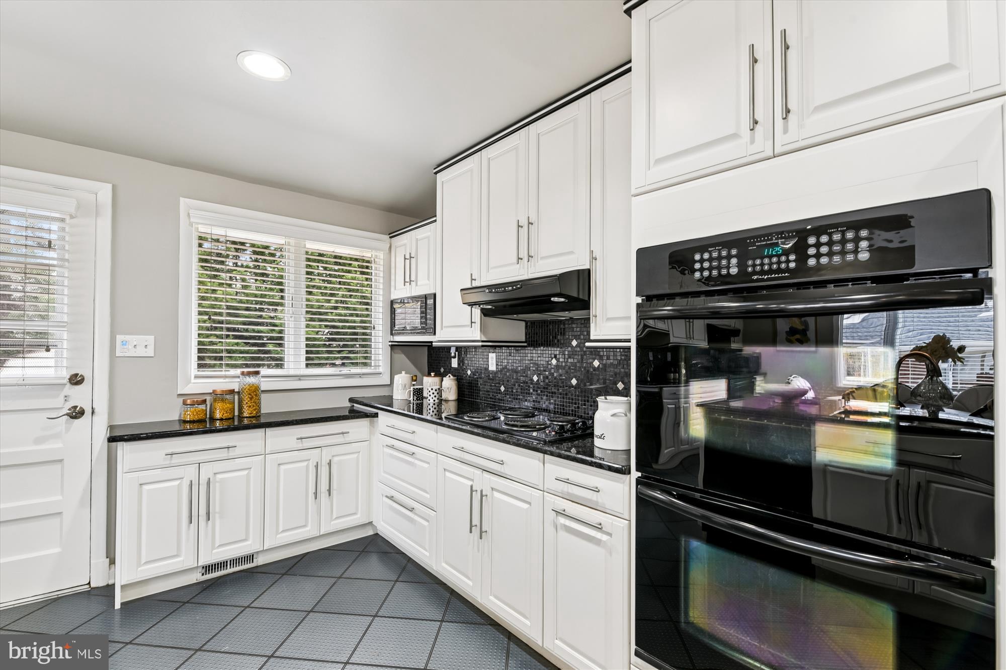 3309 Olympia Avenue Baltimore, MD 21215 - Photo 16 of 41 a kitchen with white cabinets and appliances