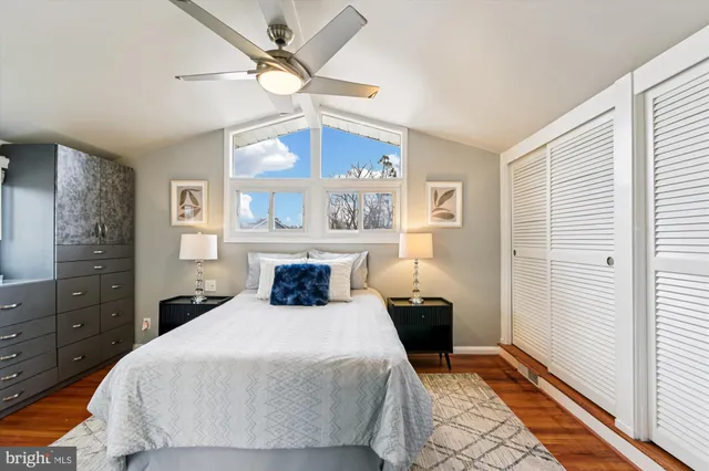 a bedroom with a large bed and a window