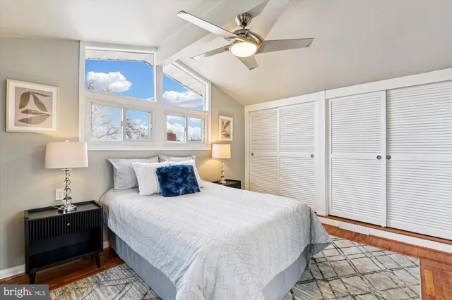 a bedroom with a bed and a lamp on the dresser