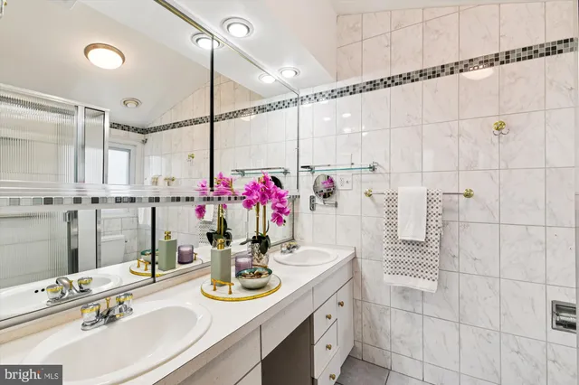 a bathroom with a sink vanity and a mirror