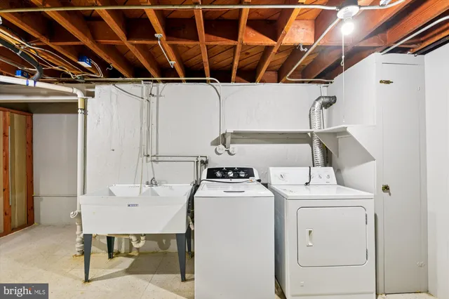 a view of walk in closet with clothes