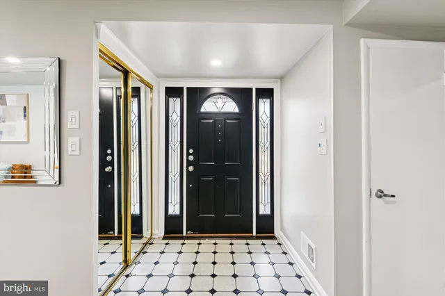 a view of a hallway with wooden floor and windows