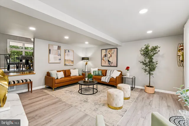 a living room with furniture and flowers