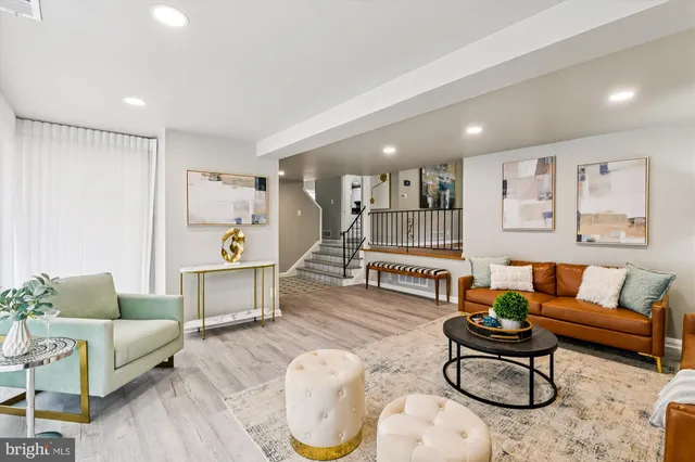 a living room with furniture a rug and a table
