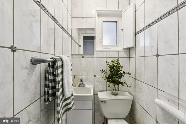 a bathroom with a sink toilet and mirror