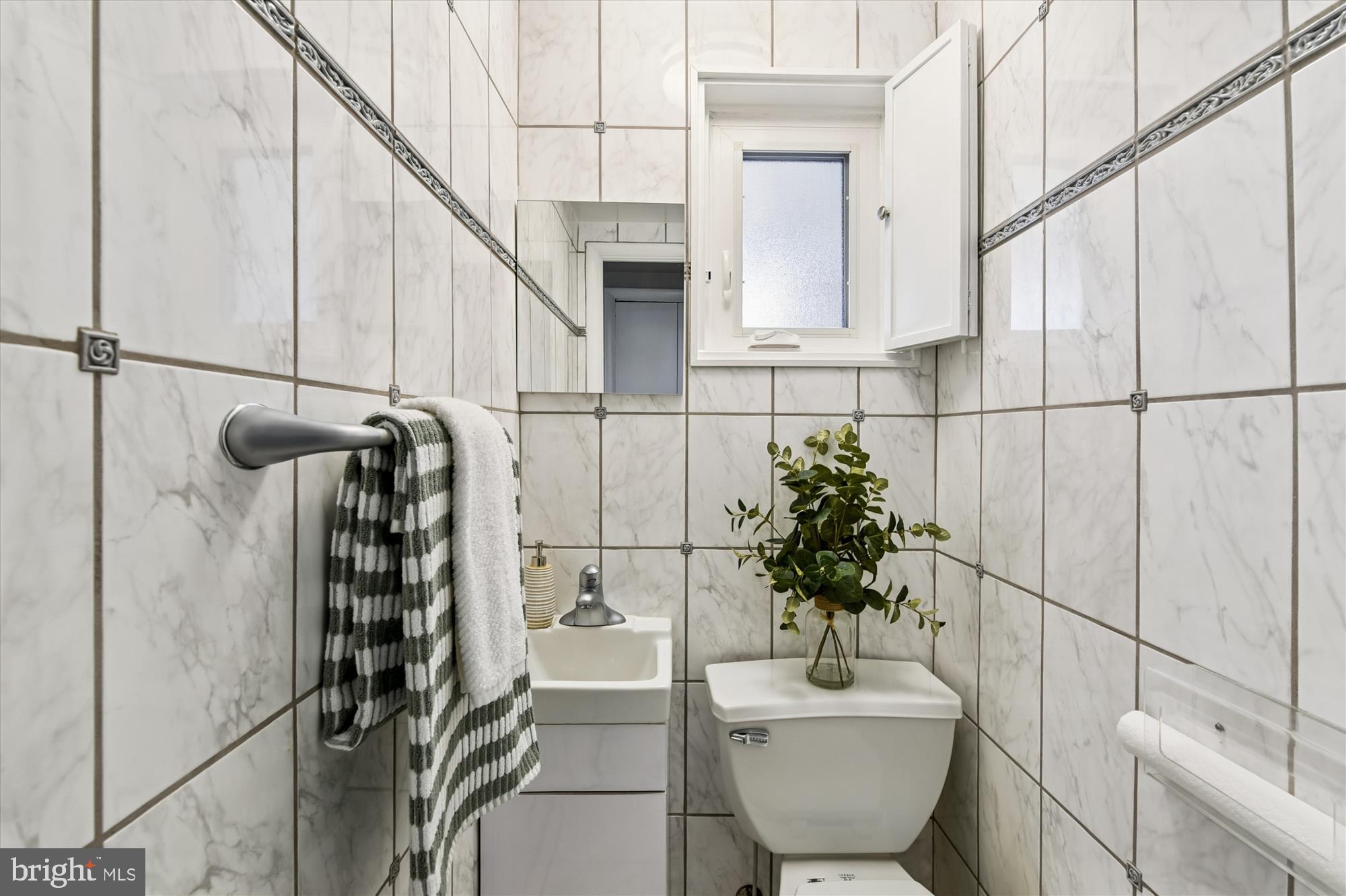 3309 Olympia Avenue Baltimore, MD 21215 - Photo 9 of 41 a bathroom with a sink toilet and mirror