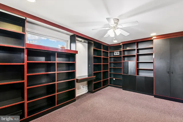 a view of an empty room with a empty space cabinets with a window