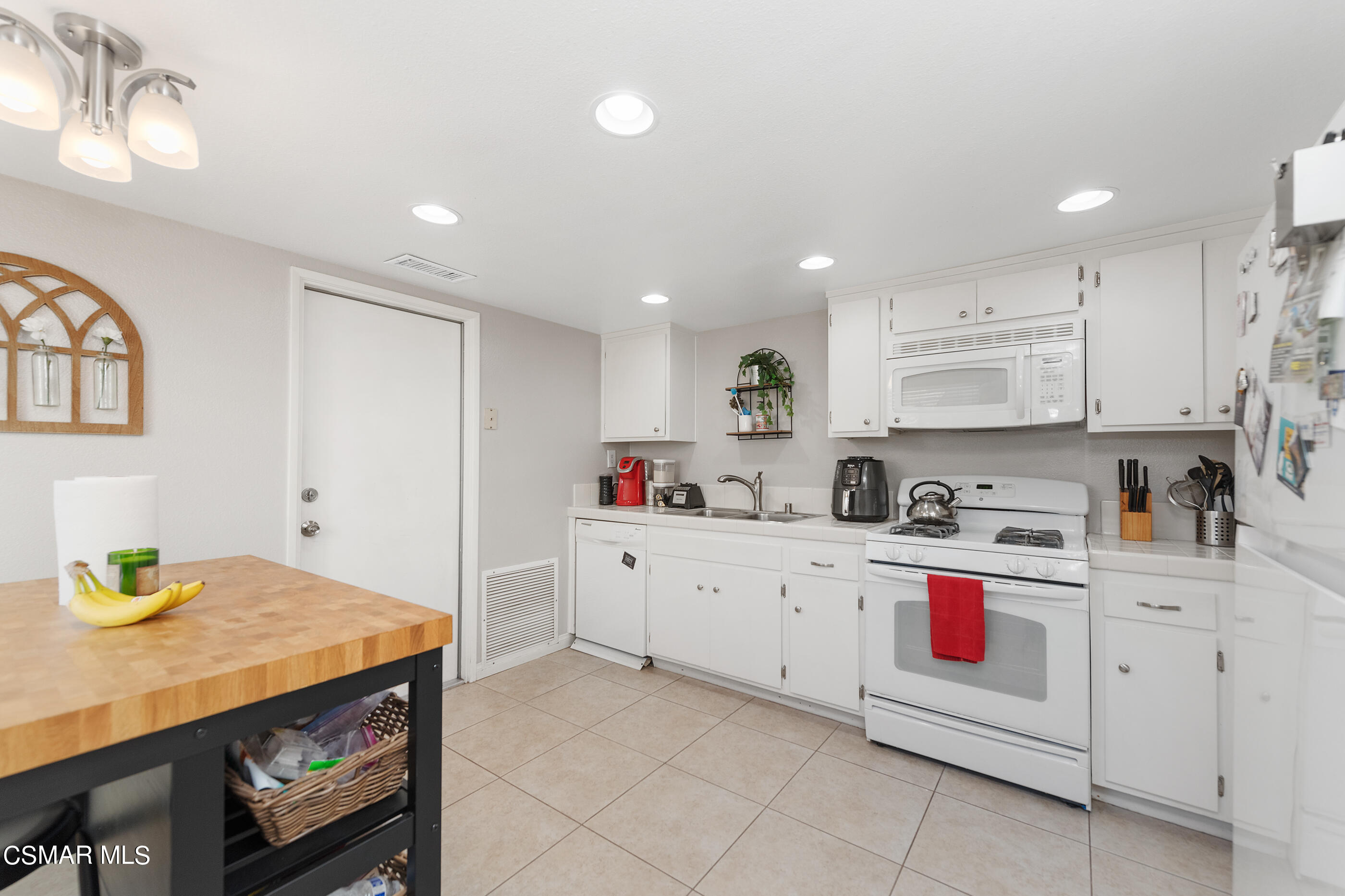 3369 Manorgate Place Simi Valley, CA 93065 - Photo 12 of 29 a kitchen with cabinets and wooden floor