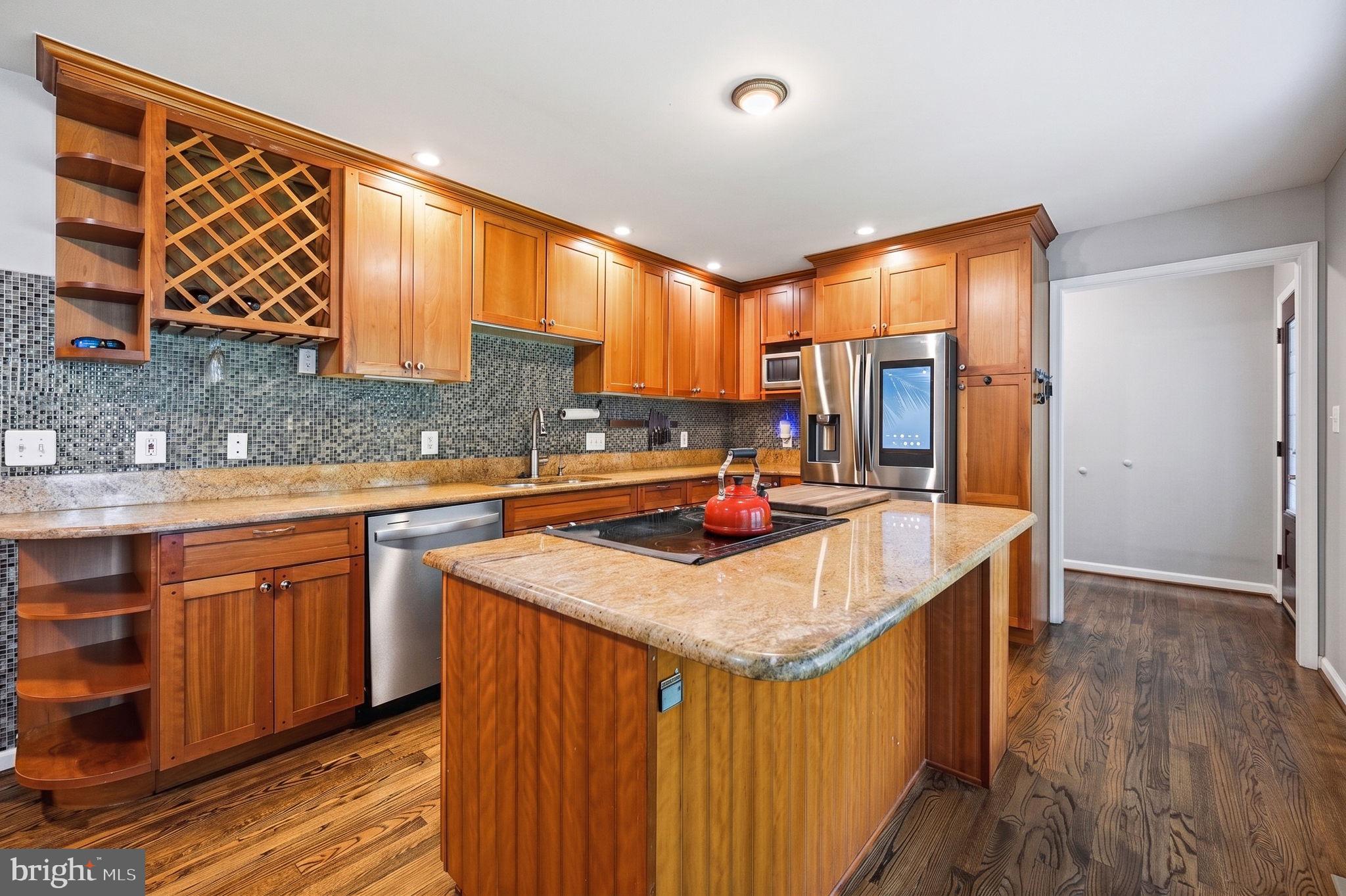 2506 Pinoak Lane Reston, VA 20191 - Photo 3 of 33 a kitchen with stainless steel appliances granite countertop sink stove and wooden cabinets