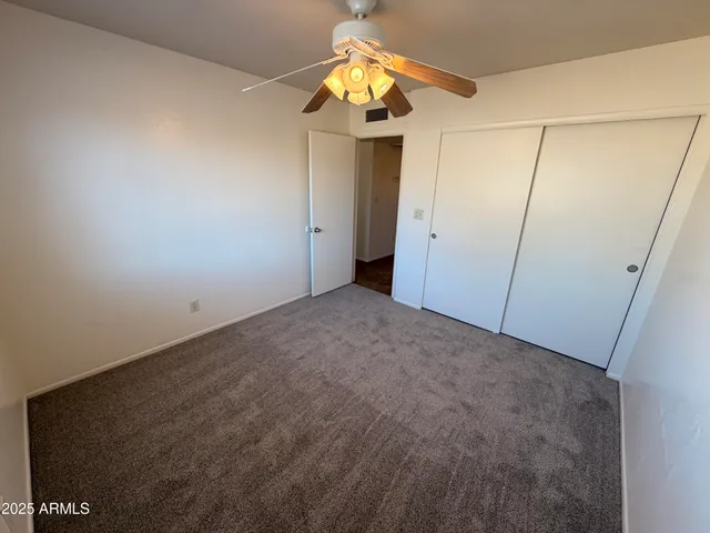 a view of a chandelier fan and closet in a room