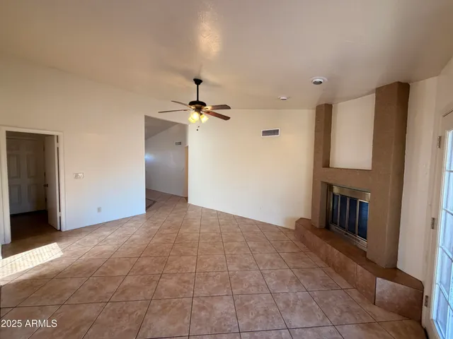 a view of an empty room with a fireplace