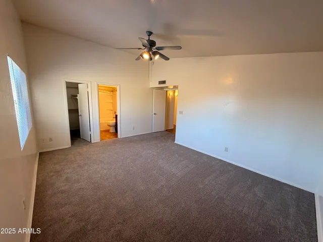 a view of empty room with ceiling fan