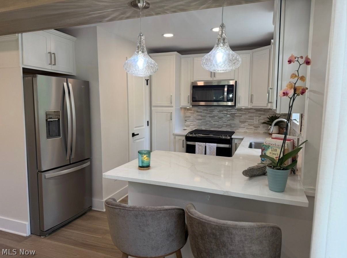 5366 Barton Road North Ridgeville, OH 44039 - Photo 20 of 49 Kitchen with brand new appliances, quartz countertops, recessed lighting, new cabinetry , stone mosaic backsplash and more.