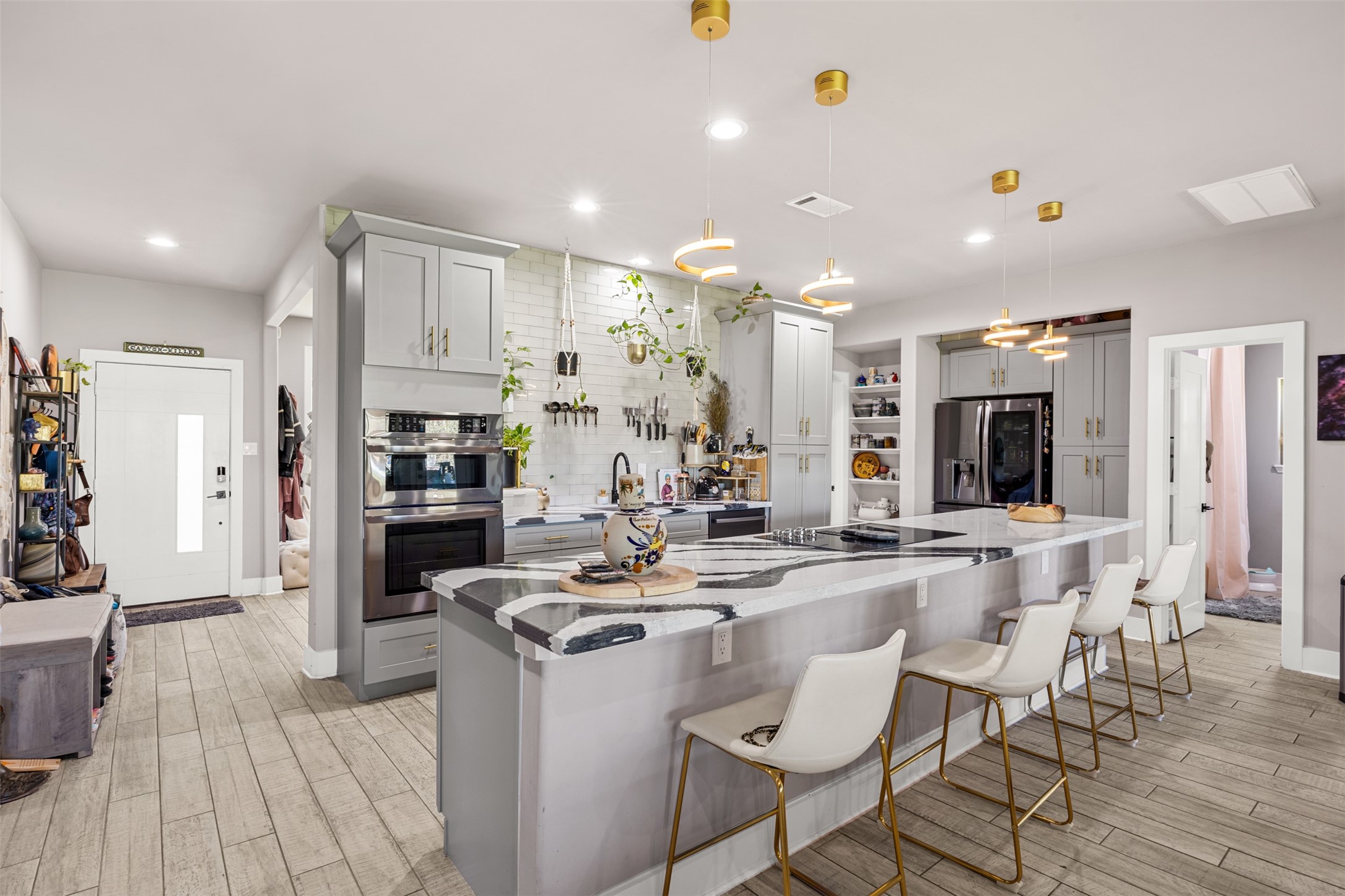 4425 Fuqua Street Houston, TX 77047 - Photo 11 of 49 a kitchen with stainless steel appliances kitchen island granite countertop a stove and a refrigerator