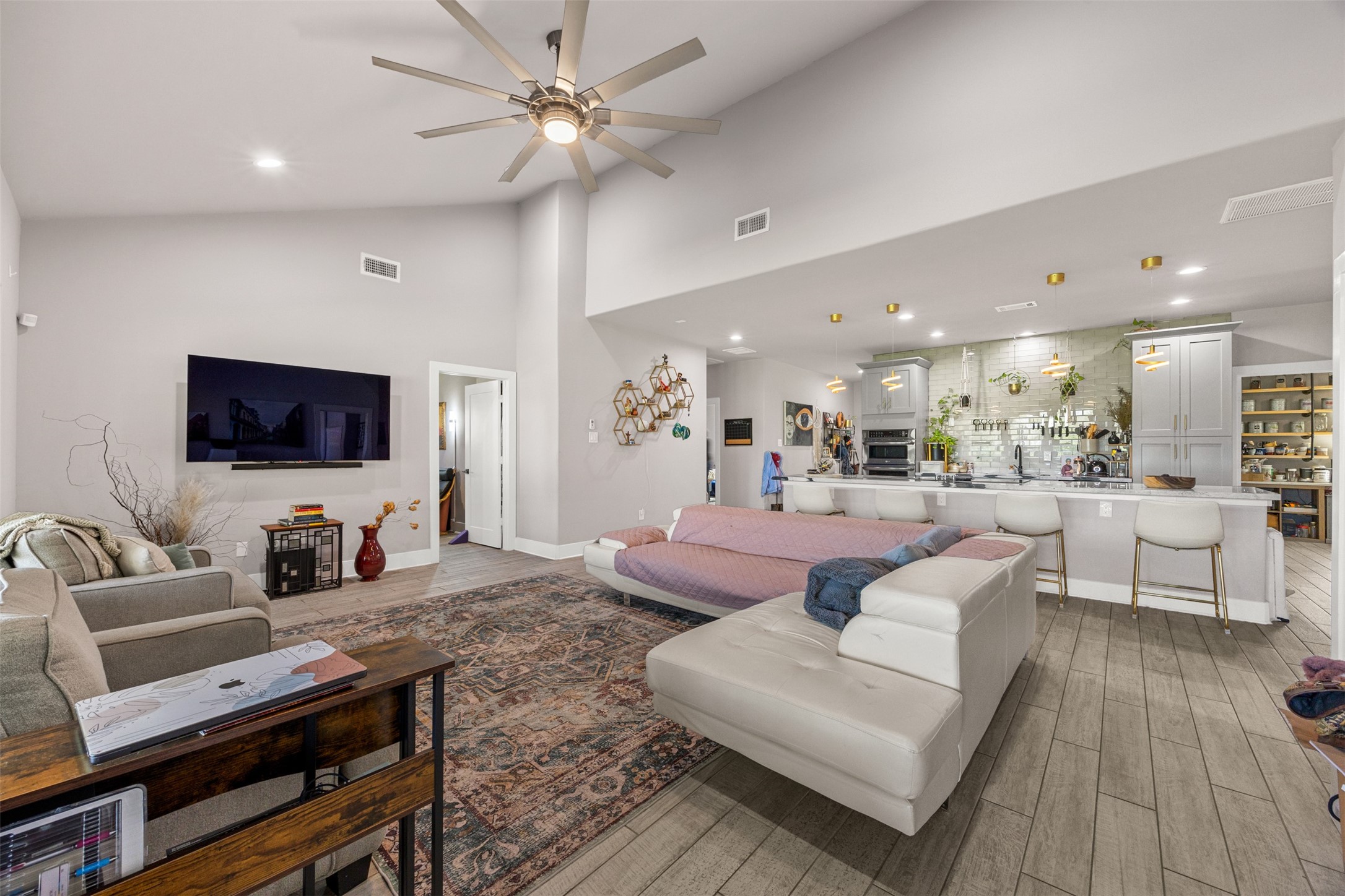 4425 Fuqua Street Houston, TX 77047 - Photo 19 of 49 a living room with furniture a flat screen tv and kitchen view