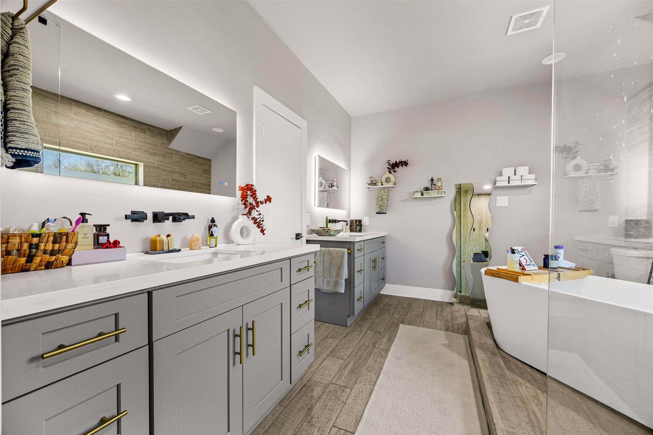 4425 Fuqua Street Houston, TX 77047 - Photo 27 of 49 a kitchen with a sink dishwasher stove and white cabinets with wooden floor