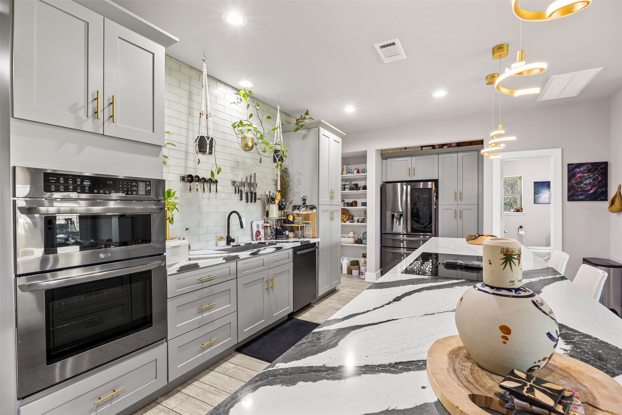4425 Fuqua Street Houston, TX 77047 - Photo 10 of 49 a kitchen with stainless steel appliances kitchen island granite countertop a stove and white cabinets