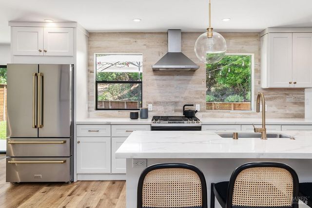 a kitchen with a stove a refrigerator and a sink