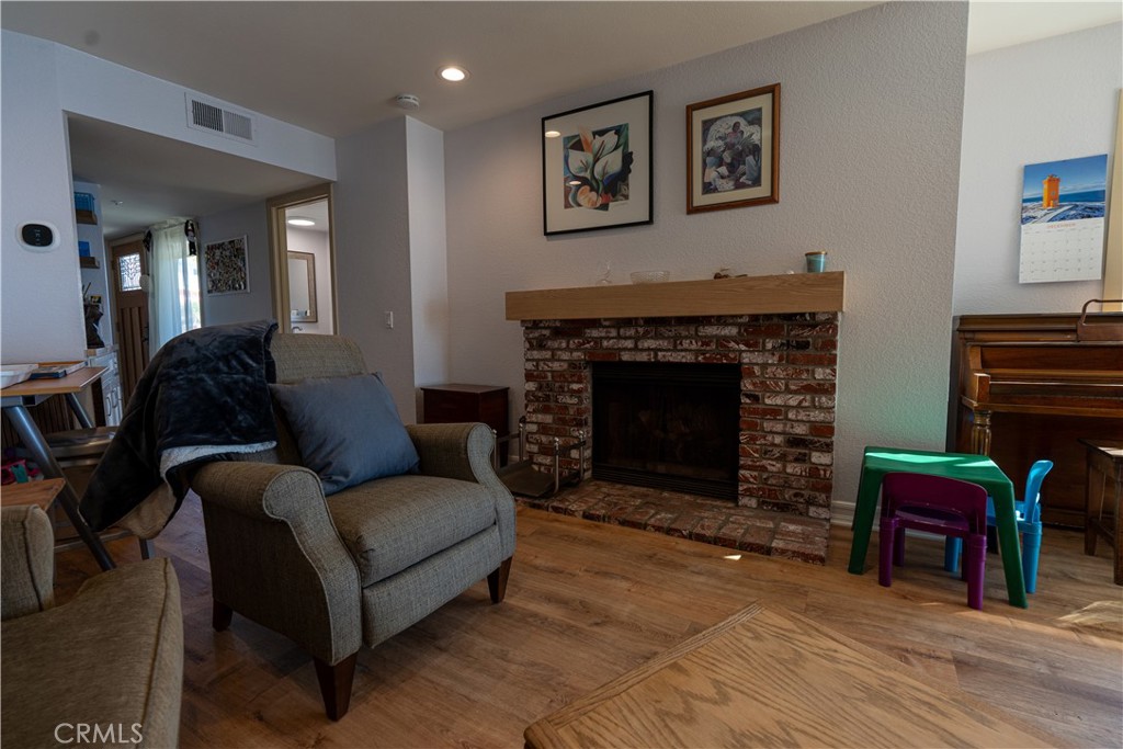 258 West Escalones, Unit 6R San Clemente, CA 92672 - Photo 13 of 22 a living room with furniture a fireplace and a piano