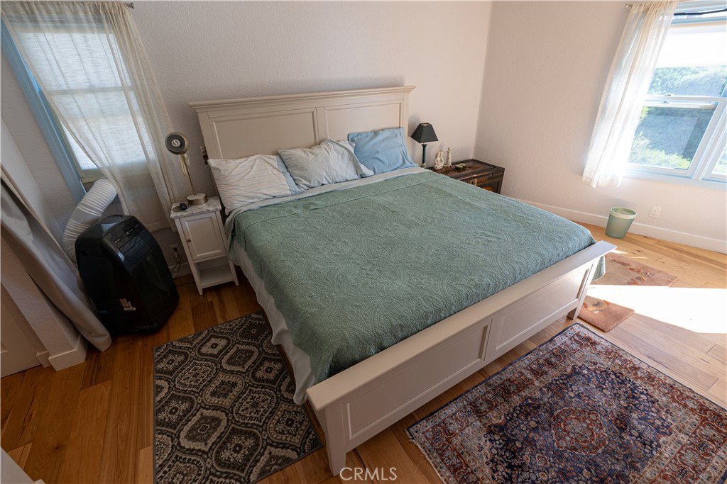 258 West Escalones, Unit 6R San Clemente, CA 92672 - Photo 17 of 22 a bed sitting in a bedroom next to a window