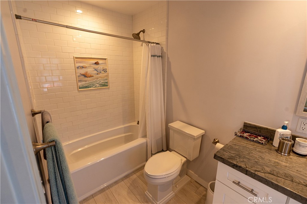 258 West Escalones, Unit 6R San Clemente, CA 92672 - Photo 19 of 22 a bathroom with a granite countertop toilet sink and shower