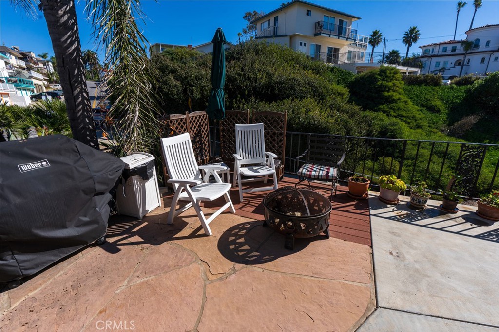 258 West Escalones, Unit 6R San Clemente, CA 92672 - Photo 6 of 22 a view of a patio with table and chairs and potted plants